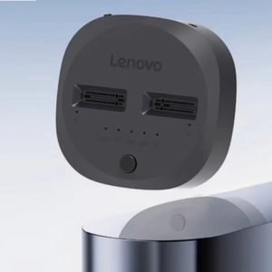 Angled top-down product rendering displaying the dual slot interface, front function button, progress indicators, and metallic base frame.