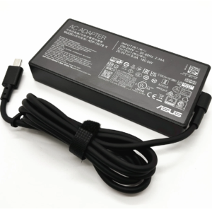 Perspective close-up of the power brick showcasing compliance certifications, ASUS branding, strain relief housing, velcro cable tie, and USB-C output connector.