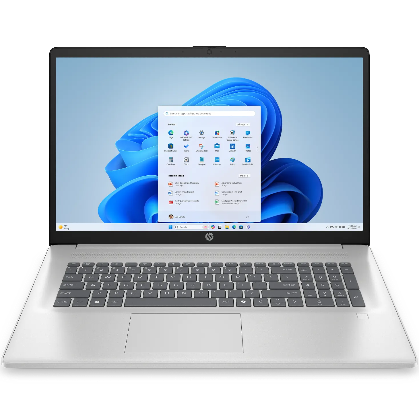 Direct front-facing view of the open natural silver HP AI 17-cn5xxx laptop displaying its 17.3-inch HD screen showing the Windows 11 desktop, top HD webcam notch, full-sized keyboard deck with number pad, top speaker grille array, fingerprint sensor on the palm rest, and large touchpad.