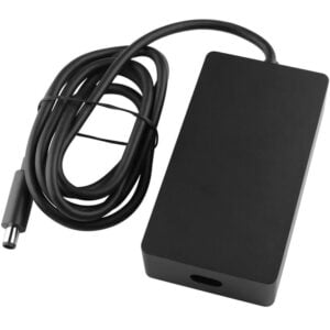 Angled top perspective view of the matte black Microsoft Surface Dock 2 199W power adapter brick showcasing its clean housing design, C8 AC inlet port, and coiled DC output cord with a 7.4x5.0mm barrel tip.