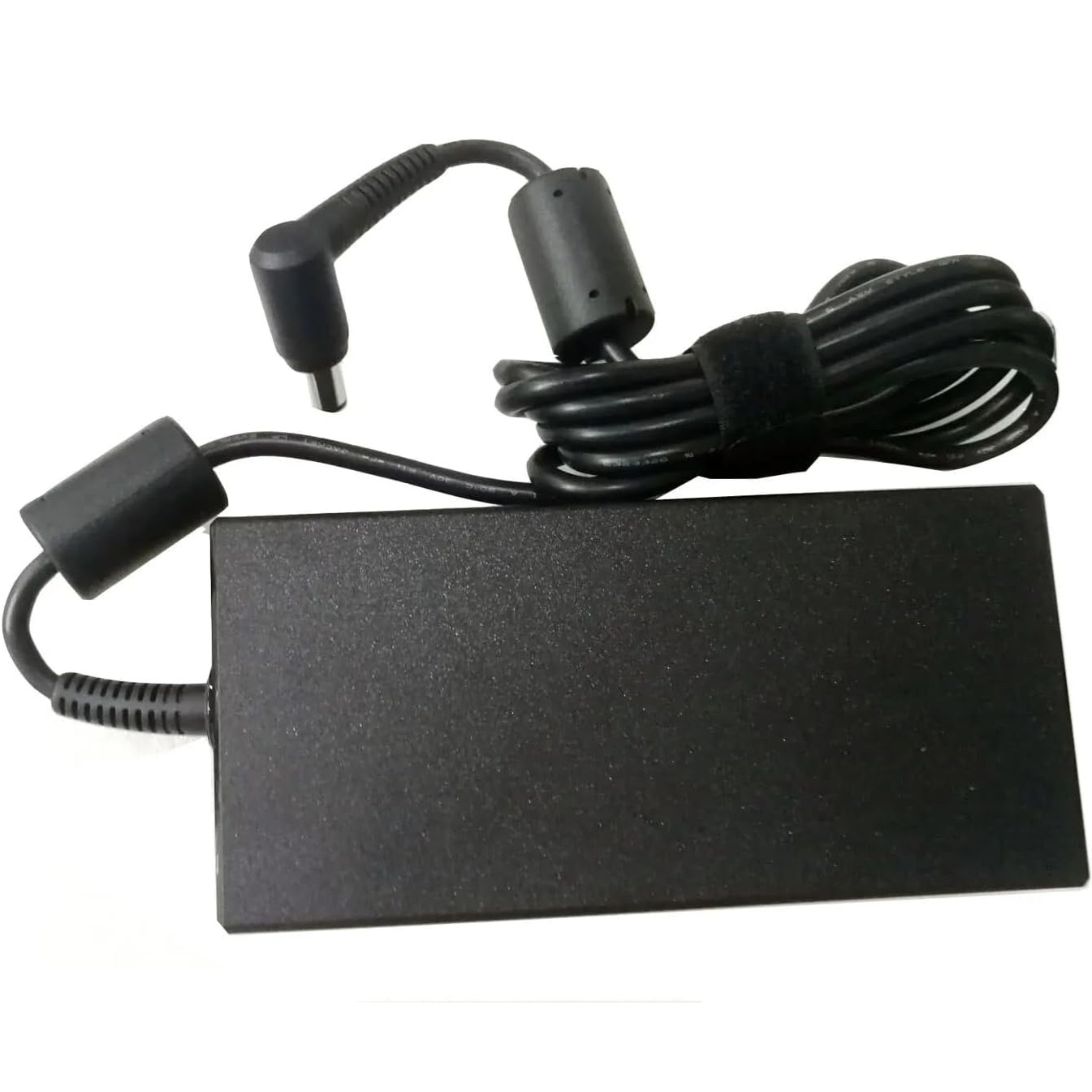 Top-side view of the black AC power adapter showing the clean, matte rectangular casing, the integrated output cable strain relief, and the coiled DC cord with a ferrite bead.