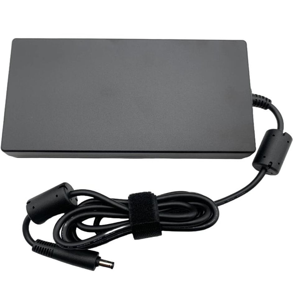 Top-side view of the black AC power brick showcasing the clean, matte rectangular casing surface, the integrated output cable strain relief, and the coiled DC cord.
