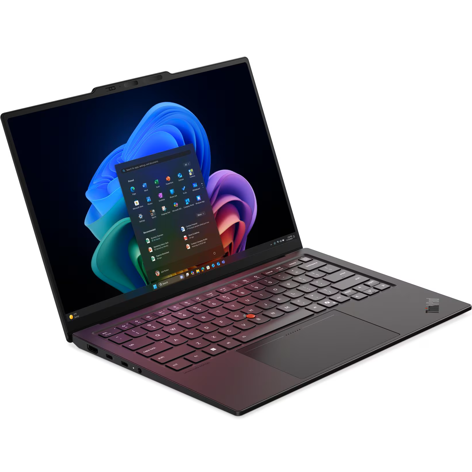 Front-left angled view of the open ThinkPad X1 Carbon Gen 14 AURA Edition showcasing its slim chassis, red TrackPoint, glass touchpad, and 14-inch 2.8K 120Hz OLED screen displaying the Windows 11 Start menu.