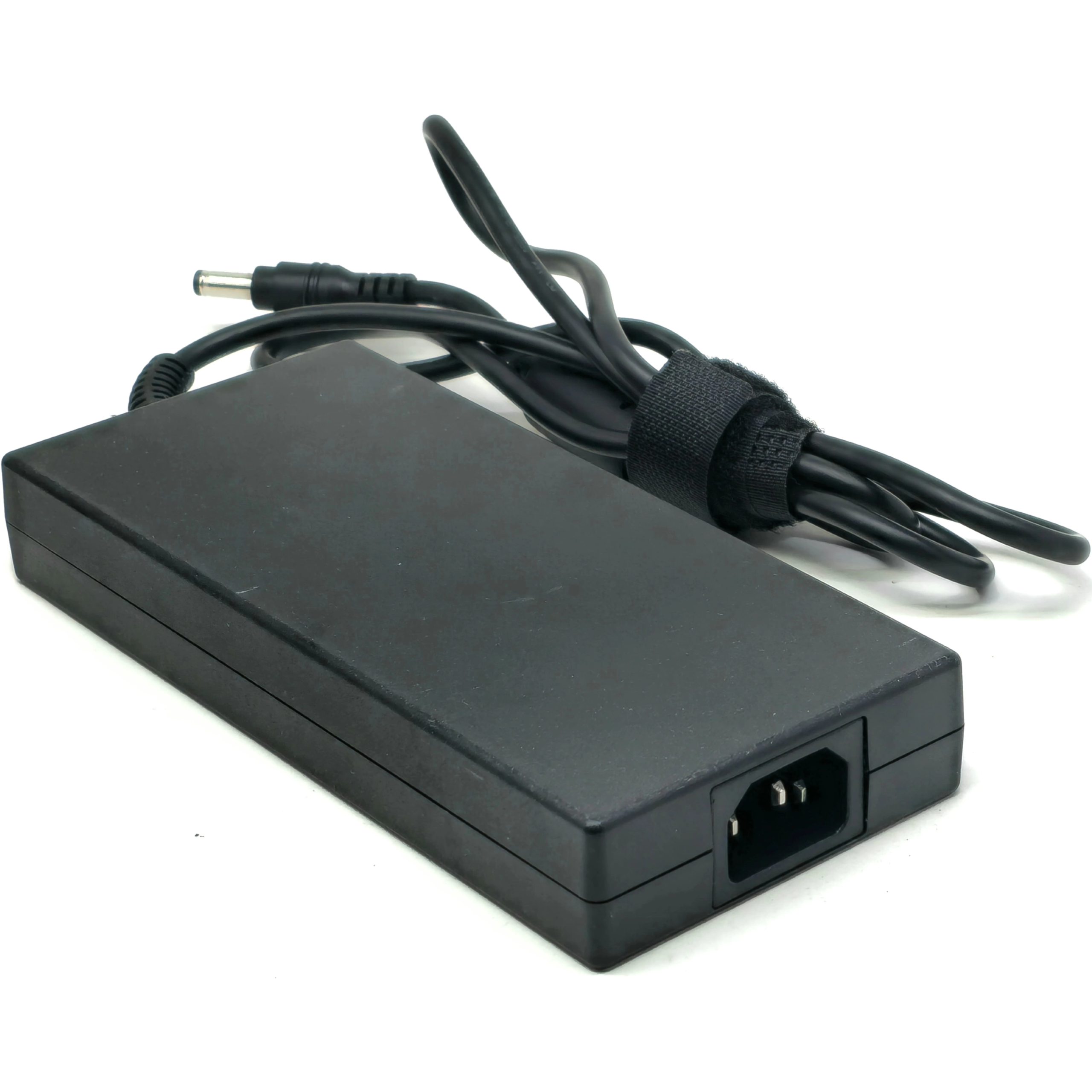 Perspective view of the power adapter showcasing the C14 AC inlet socket on the end, the smooth matte-black casing, and the coiled output cable.