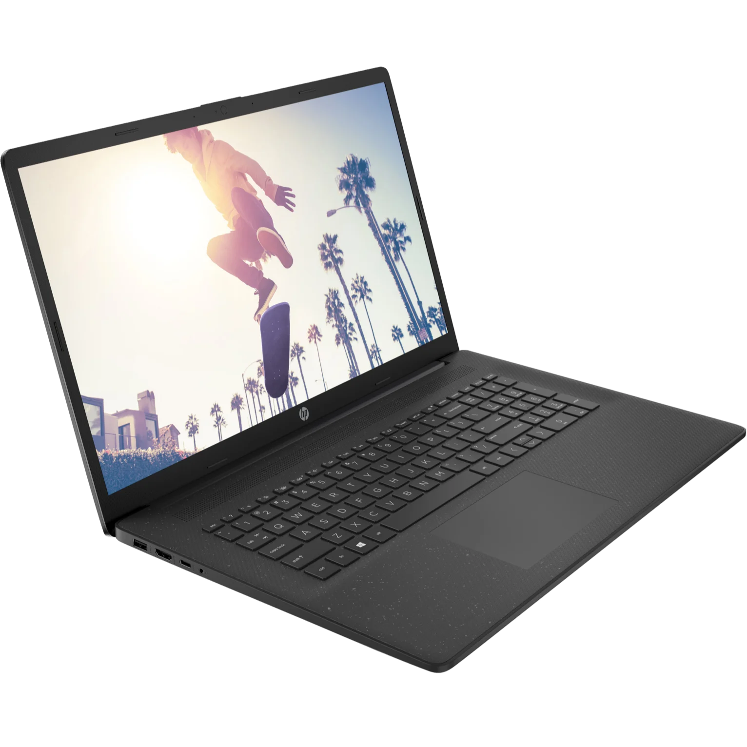 Angled front-right perspective view of the open textured black HP 17T-CN400 laptop showcasing its 17.3-inch HD+ display running Windows 11 with a skateboard lifestyle wallpaper, slim bezels featuring a top webcam notch, matching textured black keyboard deck with a dedicated numeric keypad, and a centered touchpad.
